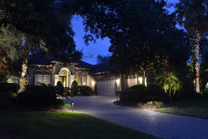 Well-lit home and driveway by perfectly placed landscape lighting