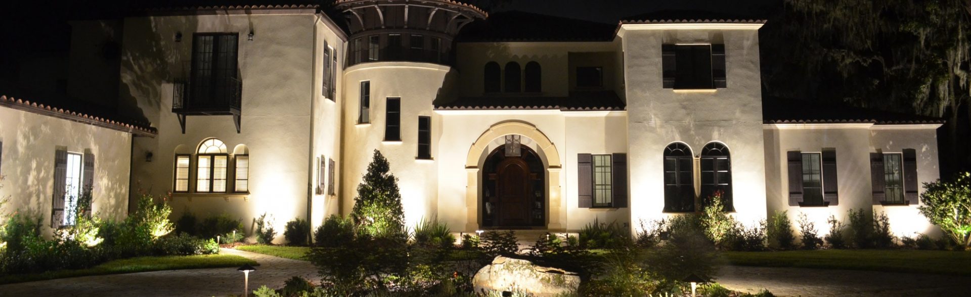 Large home with exterior lighting